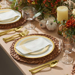 White and gold plates styled on a Thanksgiving table with pumpkins