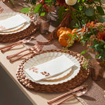 Ivory rose gold scalloped plates styled on a Thanksgiving table with pumpkins