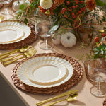 Ivory gold scalloped plates styled on a Thanksgiving table with pumpkins