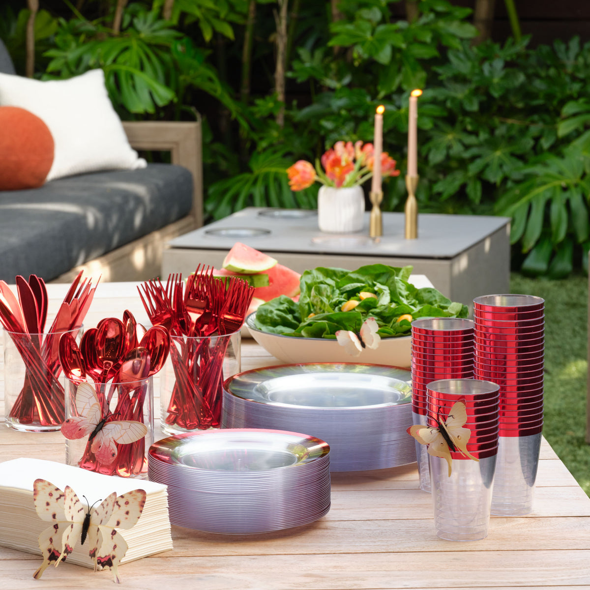 Clear red plates and cutlery styled for a buffet table